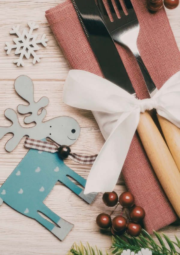 A fork and knife displayed beside holiday decorations to signify the ten healthy eating strategies for the holidays.